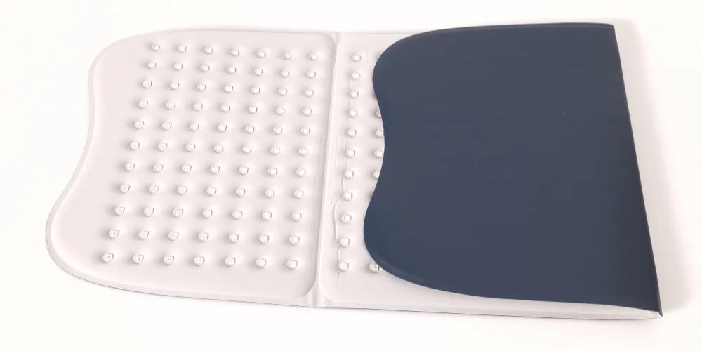 Blue and white silicone body scrubber mat with raised massage dots, flat on white background.