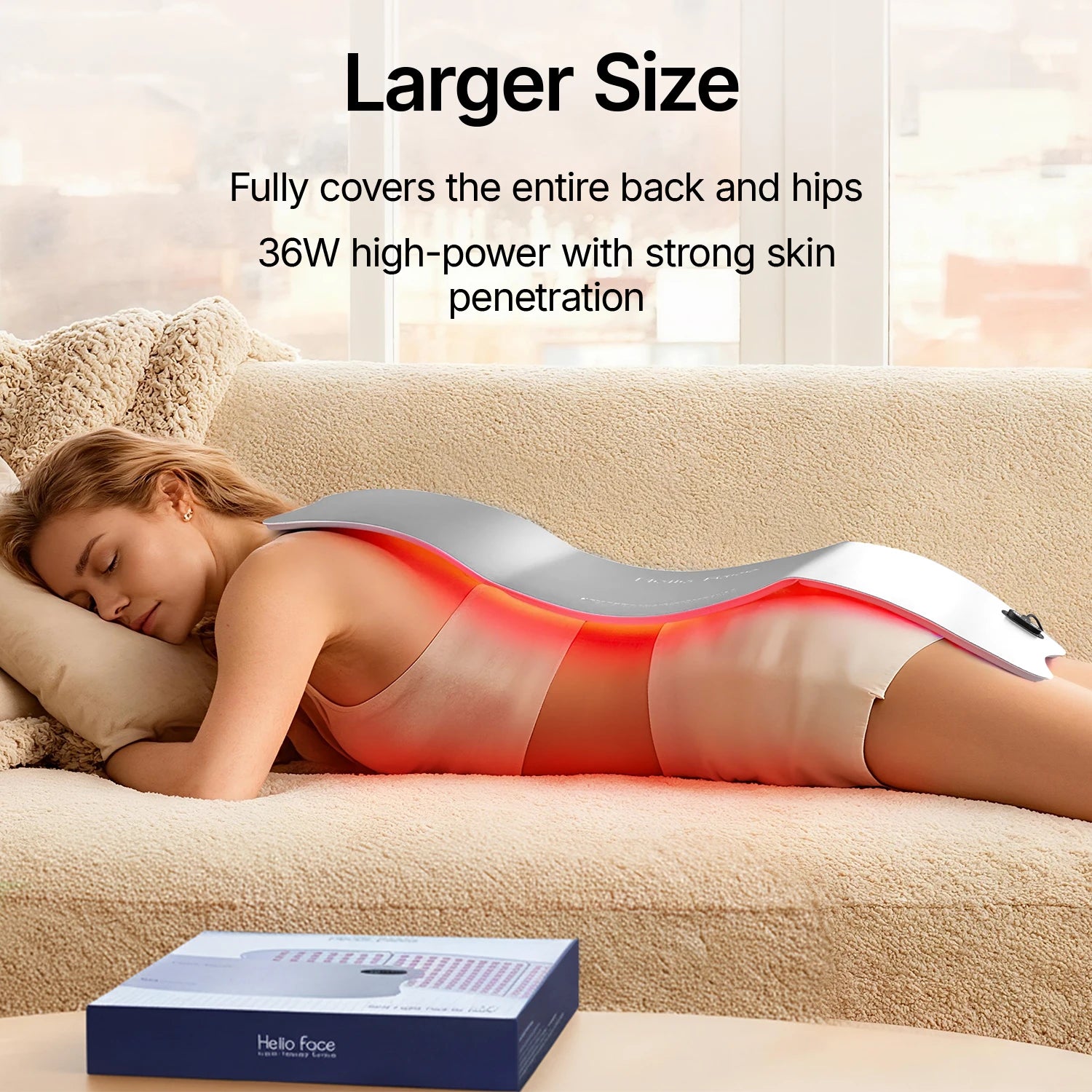 Woman using large LED light therapy pad on back and hips for skin treatment at home